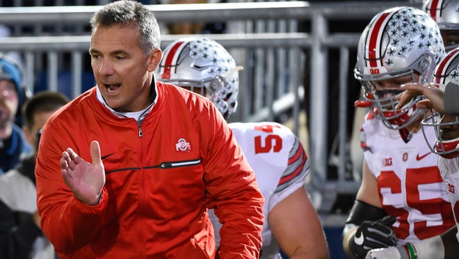 Ohio State Buckeyes head coach Urban Meyer leads his team on the field prior to the game against the Penn State Nittany Lions at Beaver Stadium on Oct. 22.