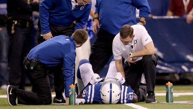 Indianapolis Colts cornerback Vontae Davis (21) is tended to after he was hit a got a concussion in the second half of their game.Indianapolis Colts defeated the Washington Redskins 49-27 Sunday, November 30, 2014, afternoon at Lucas Oil Stadium.