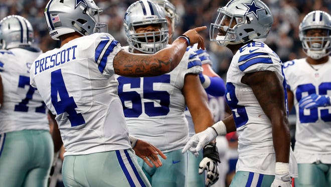 Dallas Cowboys quarterback Dak Prescott (4) celebrates with wide receiver Dez Bryant, right, as Ronald Leary (65) watches after Bryant caught a touchdown pass in the second half of an NFL football game against the Baltimore Ravens on Sunday, Nov. 20, 2016, in Arlington, Texas. (AP Photo/Michael Ainsworth)