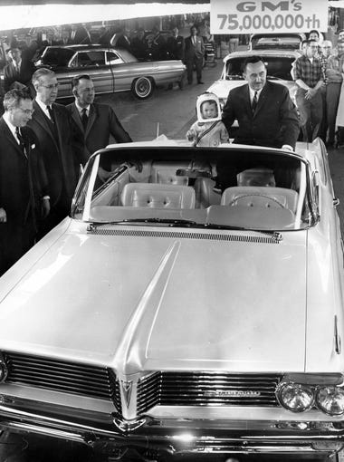 Buzz Jackson, 2, rides with GM President Elliot Estes