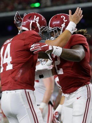 Alabama running back Derrick Henry (2) celebrates rushing for a touchdown with quarterback Jake Coker (14) during the second half of an NCAA college football game against Wisconsin, Saturday, Sept. 5, 2015, in Arlington, Texas. (AP Photo/LM Otero)  