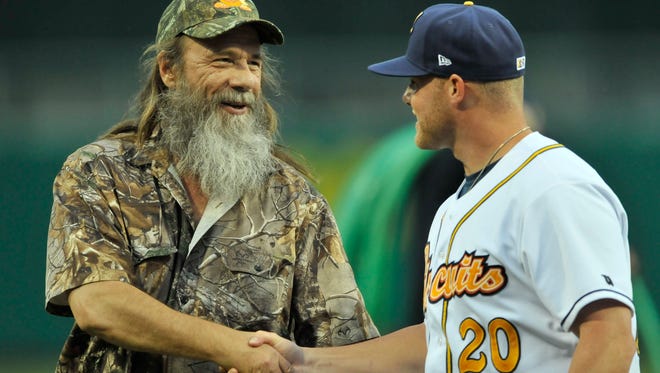 Tim Guraedy, Duck Dynasty's Mountain Man, shakes hands with Montgomery Biscuits' Matt Ramsey (20) before their game with Mississippi Braves at Riverwalk Stadium on Saturday, May 31, 2014.