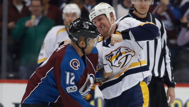 Nashville Predators left wing Cody McLeod, right, throws a punch at Colorado Avalanche right wing Jarome Iginla as they fight in the second period on Jan. 14, 2017.