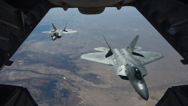 A handout photo made available by the U.S. Department of Defense shows two U.S. Air Force F-22 Raptors flying above Syria on Feb. 2.