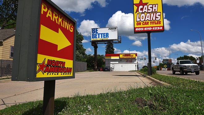 Signs for North American Title Loans, which is at the corner of East 10th Street and Blauvelt Avenue, Wednesday, May 25, 2016, in Sioux Falls.