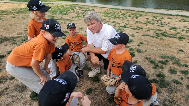 Stu Whitney instructs youth baseball players in this 2012 photo at Covell Park in Sioux Falls.