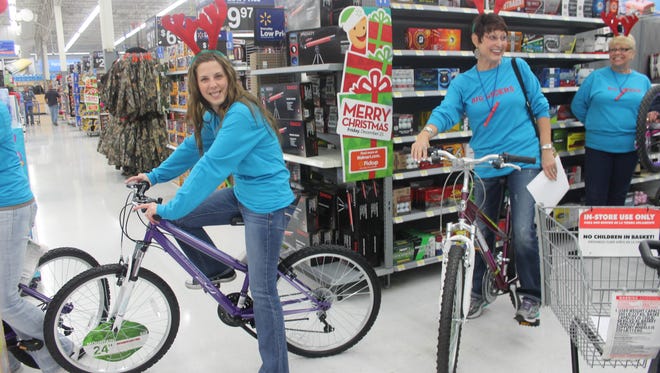 Big Givers Rachel Preston and Kathy Crispin along with others from the Worship Center in Alamogordo bought bicycles for a family in need at Wal-Mart Tuesday evening.