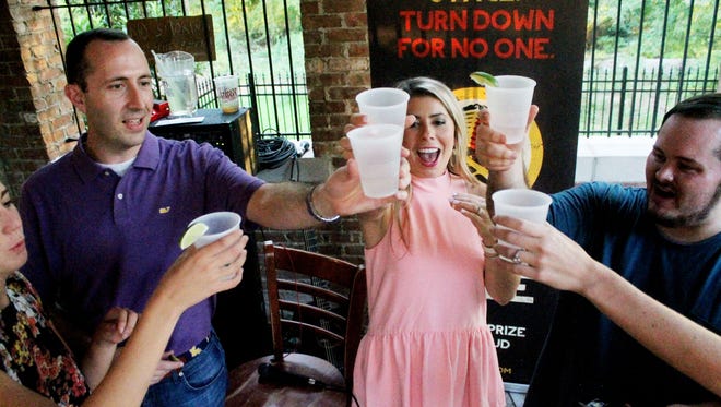 Grant Nuckolls, owner of Twisted Root, Sabrina Adsit, and Chris Lyon raise a toast during the Team Music Prize at Twisted Root Burger Company announcing the top 5 emerging bands that are competing for the Music Prize 2016 Winner's title in Shreveport on Thursday, September 9. 