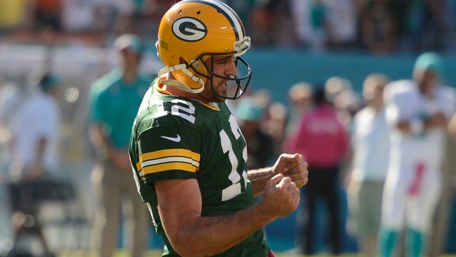 Packers quarterback Aaron Rodgers celebrates after throwing the game winning-touchdown in the closing seconds against the Miami Dolphins.