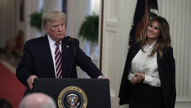 U.S. President Donald Trump pauses next to First Lady Melania Trump after his remarks about his Senate impeachment trial in the East Room at the White House in Washington on February 6, 2020.