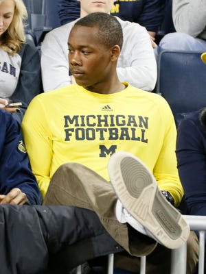Tyrone Wheatley Jr., son of former Michigan running back Tyrone Wheatley who was just hired as Michigan's new running back coach, sits in the stands watching U-M's 58-44 win over Nebraska Tuesday at Crisler Center.