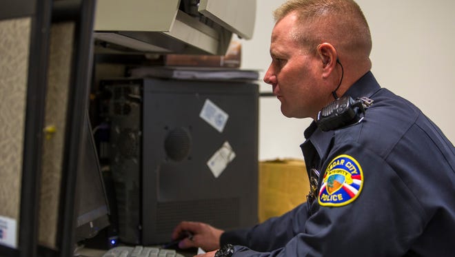 Officer Ryan Coleman of the Cedar City Police Department works at his desk, Wednesday, Jan. 13, 2016.