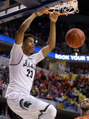 In this March 12, 2016, file photo, Michigan State's Deyonta Davis (23) dunks as Maryland's Robert Carter (4) watches in the second half of an NCAA college basketball game during the semifinals of the Big Ten Conference tournament in Indianapolis.