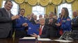 Trump holds a NASA flight jacket presented to him by