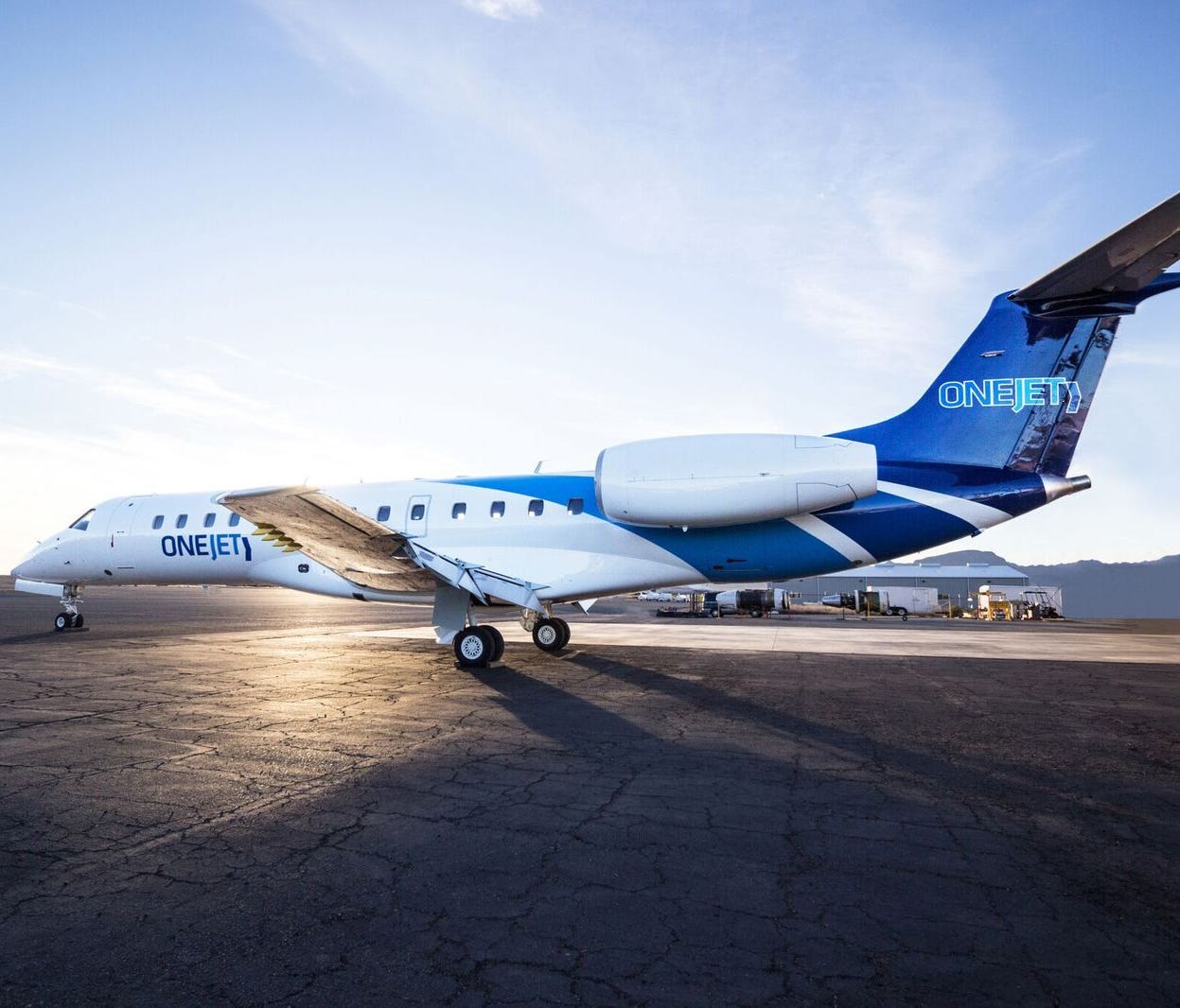 This image, provided by OneJet, shows and Embraer regional jet in the company's color.