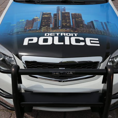 The Detroit skyline on the hood of a Detroit Police Department cruiser.