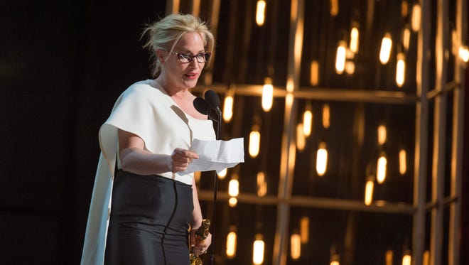 Patricia Arquette accepts the Oscar for best supporting actress on Feb. 23.