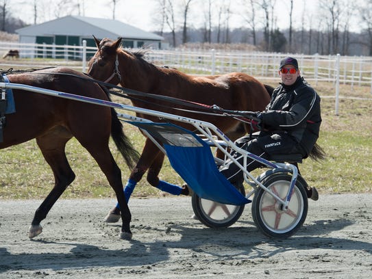 Steven Nason of Freedom, New Hampshire, on the practice track with Monkey and Geremel Hanover, at Track View Farm in Hartly.