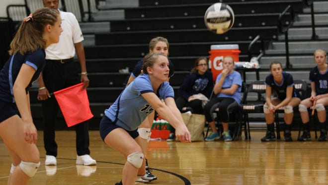 Adena's Carly Carroll digs a ball during Saturday's Division III District Final match against Zane Trace at Waverly High School.
