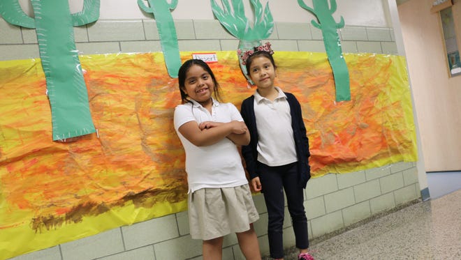 Proud to have prepared their school exhibit of the desert, Clinton School students (l-r) Melisa Perez Alvarado and Angely Rivera Chiquillo. First grade, are already experts on the cactus.