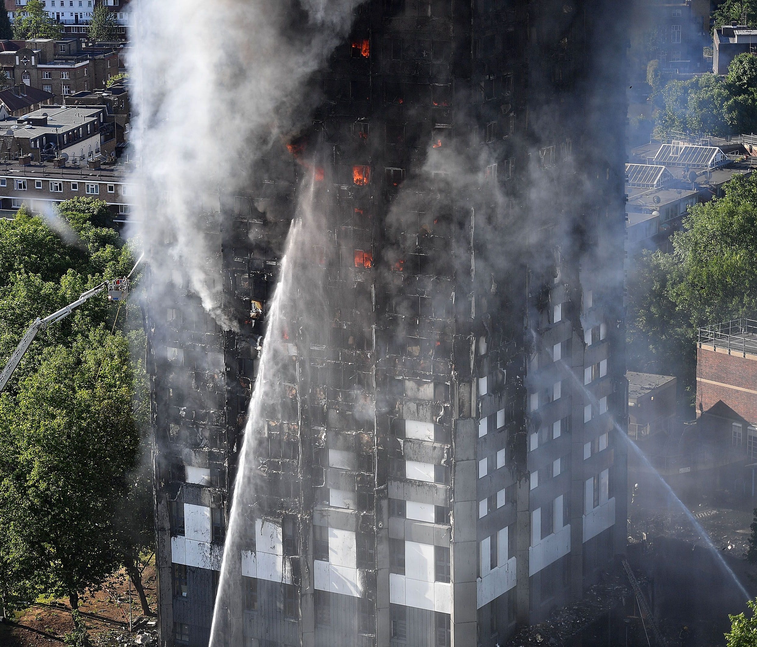 Fire fighters tackle a huge fire that engulfed the 24-story Grenfell Tower in Latimer Road, West London in the early hours of this morning on June 14, 2017 in London, England.
