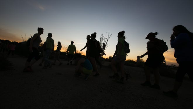 Hikers make their way toward a trail for the Full Moon Hike at McDowell Mountain Regional Park in Fountain Hills, AZ on July 2, 2015.