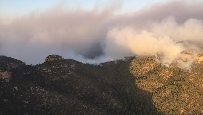 Smoke rises into the air from the Juniper Fire, which is burning in the Sierra Ancha Wilderness of the Tonto National Forest.
