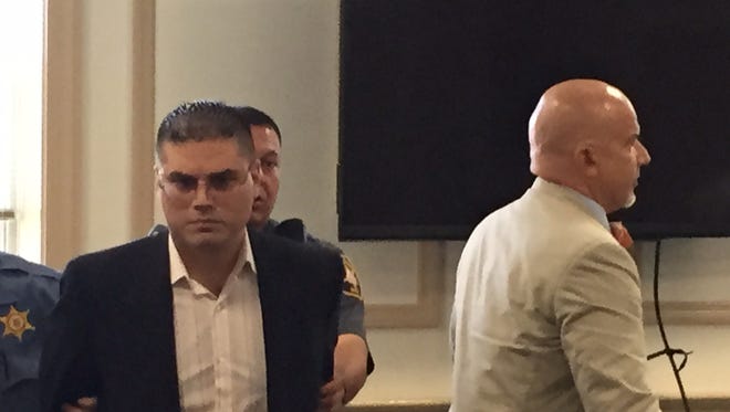 Giuseppe Iellimo, in black jacket, is taken in handcuffs out of Superior Court, Morristown, on Aug. 3, 2016 after sentencing for criminal sexual contact of 15-year-old girl.