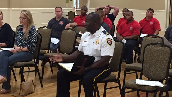 Hattiesburg Fire Chief Paul Presley, center, and a group of Hattiesburg firefighters attend a Hattiesburg Council of Neighborhoods meeting Thursday at the C.E. Roy Community Center.