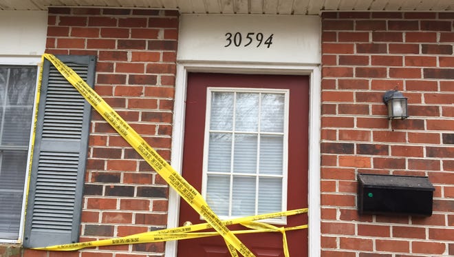 Crime scene tape covers the door of a Pine Knoll Drive townhome in Princess Anne after an incident that left three people hospitalized on Dec. 6, 2016.