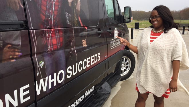 Jinawa McNeil, interim director of admission at UMES, points at a van designed to help with recruitment of students.