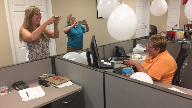 Laurie Blandford and Colleen Wixon help document Louise Phillipine’s last day of work Sept. 1, 2017, at TCPalm, Treasure Coast Newspapers and the Press Journal. Phillipine, seated, was hired as the Press Journal’s Sebastian bureau chief in 1994 after spending parts of two decades with the Easton (Pennsylvania) Express-Times.