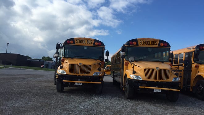 School buses are parked near Clear Creek Amana Middle Elementary School in Tiffin. A plan to build a new transportation facility would move the parking area to a secured lot and provide other amenities.