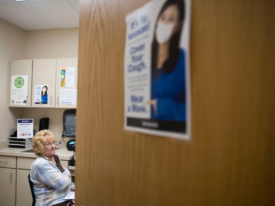 Patient Sandra McWilliams waits to receive her flu