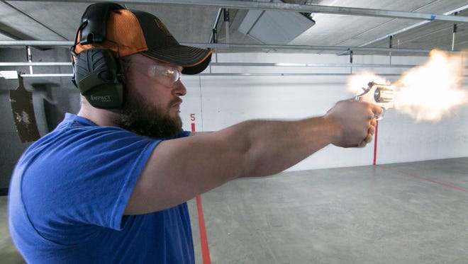 Employee Brad McClements fires a .357 Smith and Wesson 686 in the gun range at Peacemakers Gun Range in Howell May 2, 2018.