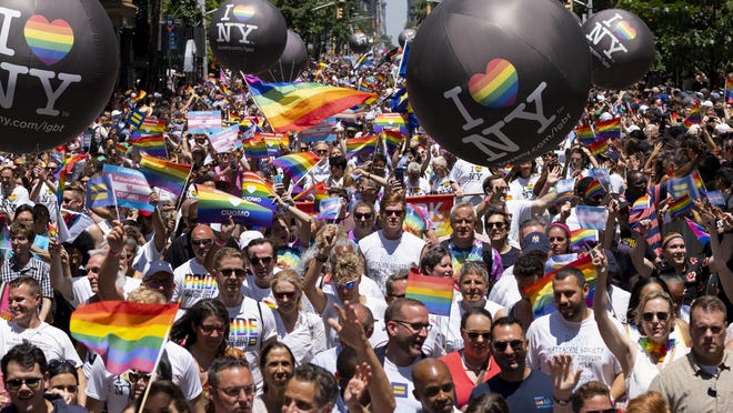 Thousands participate in the LBGTQ Pride march Sunday in New York.