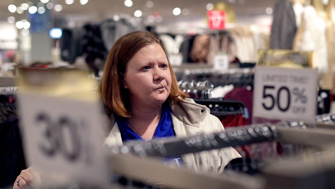 FILE - In this Nov. 28, 2015, file photo, Janae Melvin shops for gifts at Forever 21 in Kansas City, Kan. For many, holiday shopping has replaced the religious celebration of the birth of Christ as the "spirit of Christmas." (AP Photo/Charlie Riedel, File)