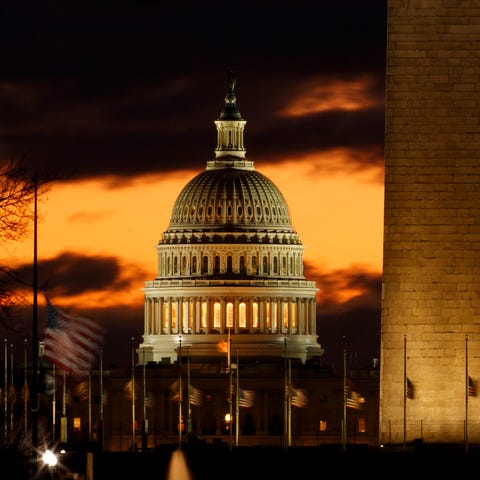 The U.S. Capitol dome is seen past the base of...