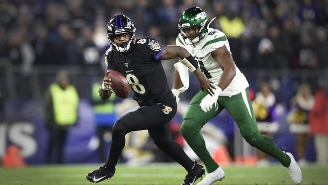 Ravens quarterback Lamar Jackson runs during the first half of a game against the Jets on Dec. 12 in Baltimore. Before Jackson dominated the NFL, he was a force to reckoned as a dual-threat high school quarterback in Palm Beach County.