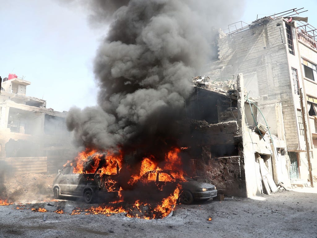 Vehicles burn  following reported government airstrike on the rebel-held town of Douma, on the eastern outskirts of the Damascus, on Feb.26, 2017. Government raids continue despite the United Nations confirmation a few days earlier that Moscow formal