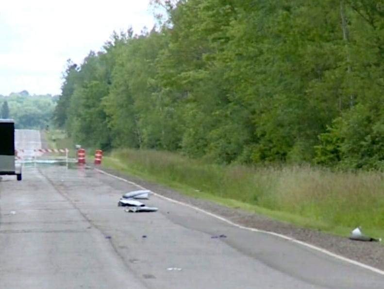 In this image made from a video provided by WAOW-TV debris from a plane crash covers the road on July, 2, 2017, near Phillips, Wis.