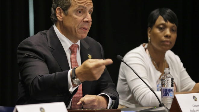 New York Gov. Andrew Cuomo speaks on July 8 about his executive order that establishes the Office of the state Attorney General as a special prosecutor in cases of police-relating killings of an unarmed civilian. Next to the governor is Constance Malcolm, mother of Ramarley Graham, a Bronx teen who was killed by police three years ago. An original manslaughter indictment against the police officer who shot Graham was thrown out on a technicality, and a second grand jury declined to indict.
