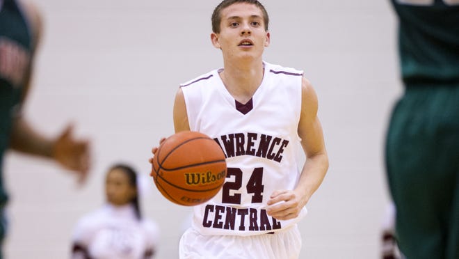 Lawrence Central High School sophomore Kyle Guy (24) brings the ball up court during the first half of the boy's variety basketball game Wednesday, December 11, 2013, at Lawrence Central High School.