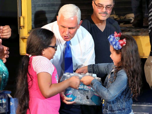 Emma Perez, 9, left, and Summer Munoz, 7, hand Pence