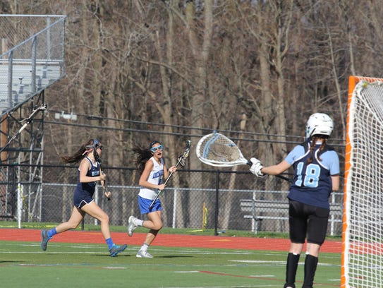 Hannah Schwartz (#4 in white) heads to the goal during