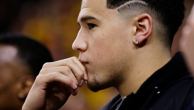Suns star Devin Booker watches Arizona State battle Oregon during Pac-12 action on Jan. 11, 2018 in Tempe, Ariz.
