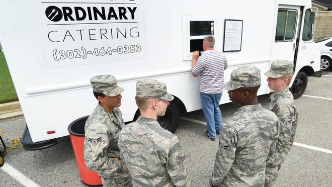 Personnel at Dover Air Force Base get lunch from a food truck near the base exchange and commissary.