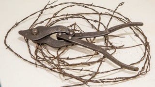 Barbed wire and World War I-era wire cutter, part of "The War to End All Wars: Artists and World War I" at the Herbert F. Johnson Museum of Art.