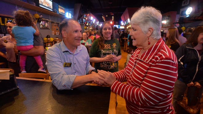 Jesse Slaughter, candidate for Cascade County Sheriff, talks with Alice Klundt during his watch party at the Sting Sports Bar on Tuesday night.