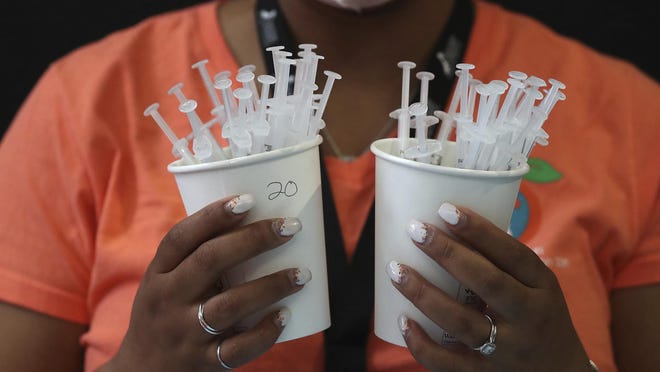 Fulton County Department of Public Health registered nurse Rosalie Pringle prepares dozens of Pfizer COVID-19 vaccinations at Mercedes-Benz Stadium on Wednesday in Atlanta.